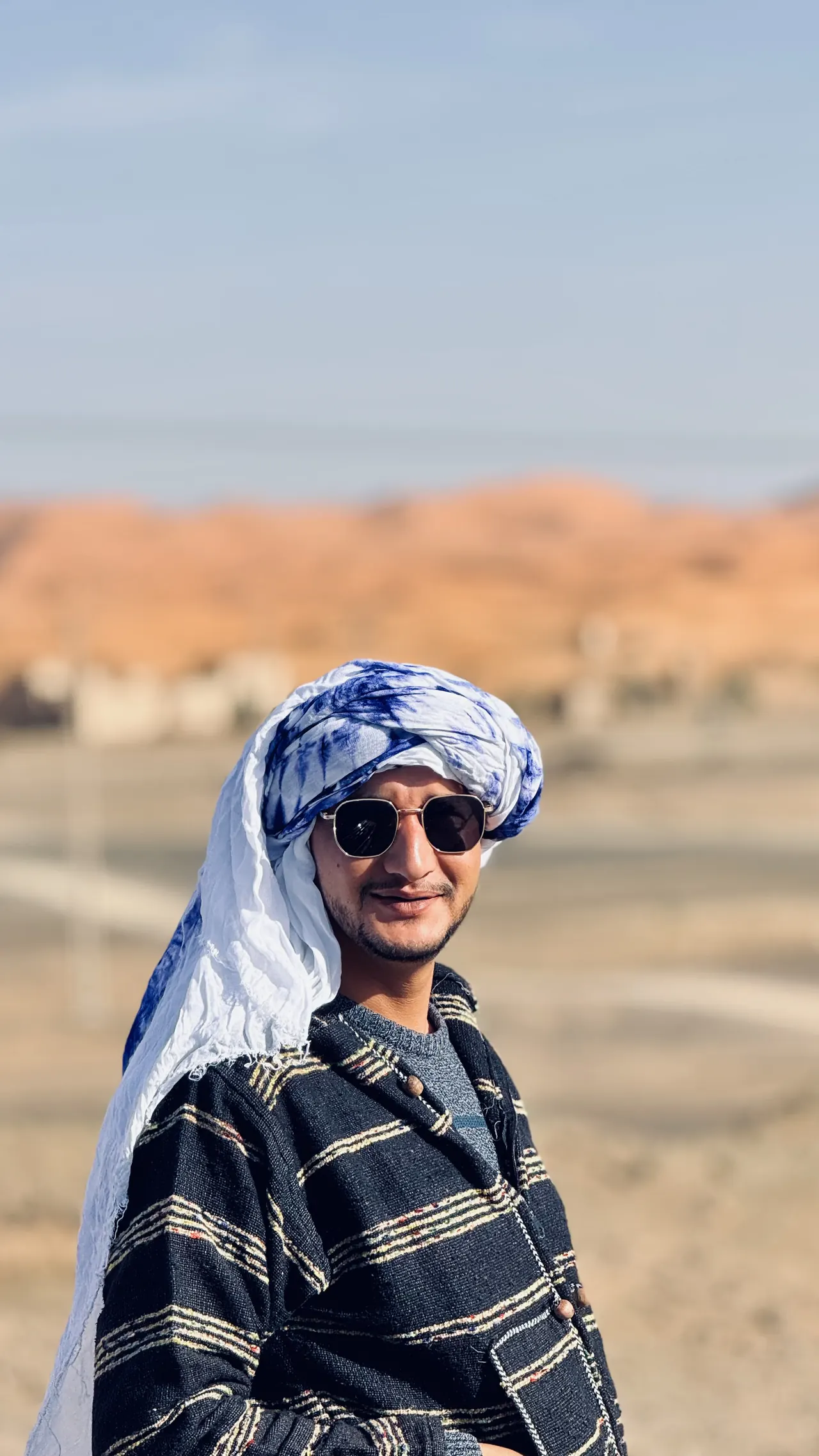 Abdel from Morocco wearing a headscarf on a desert road