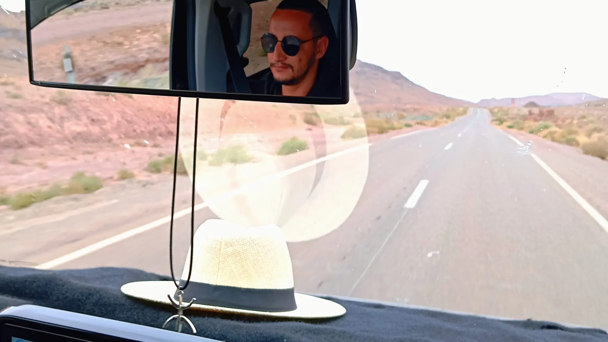 Road view from a vehicle mirror during a Morocco journey